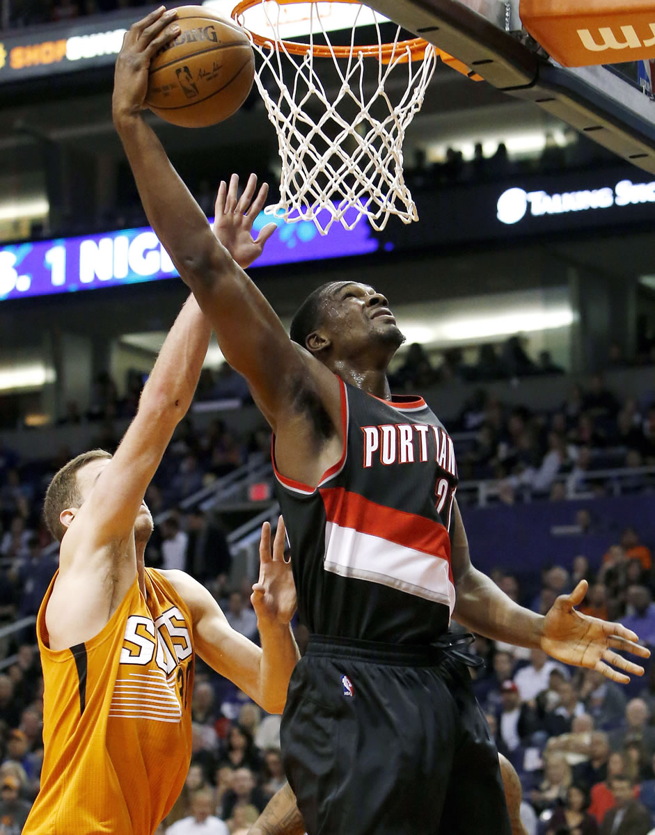 Portland Trail Blazers forward Noah Vonleh, right, scores in front of Phoenix Suns forward Jon Leuer in the first quarter during an NBA basketball game, Friday, Dec. 11, 2015, in Phoenix.