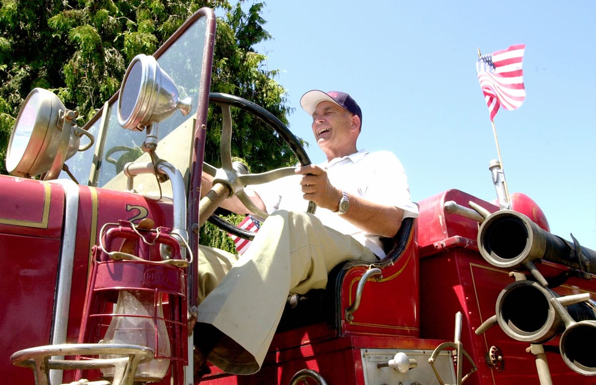 Dick Streissguth drives his 1929 Mack fire engine in 2000. He owned a dozen fire engines in various states of restoration.