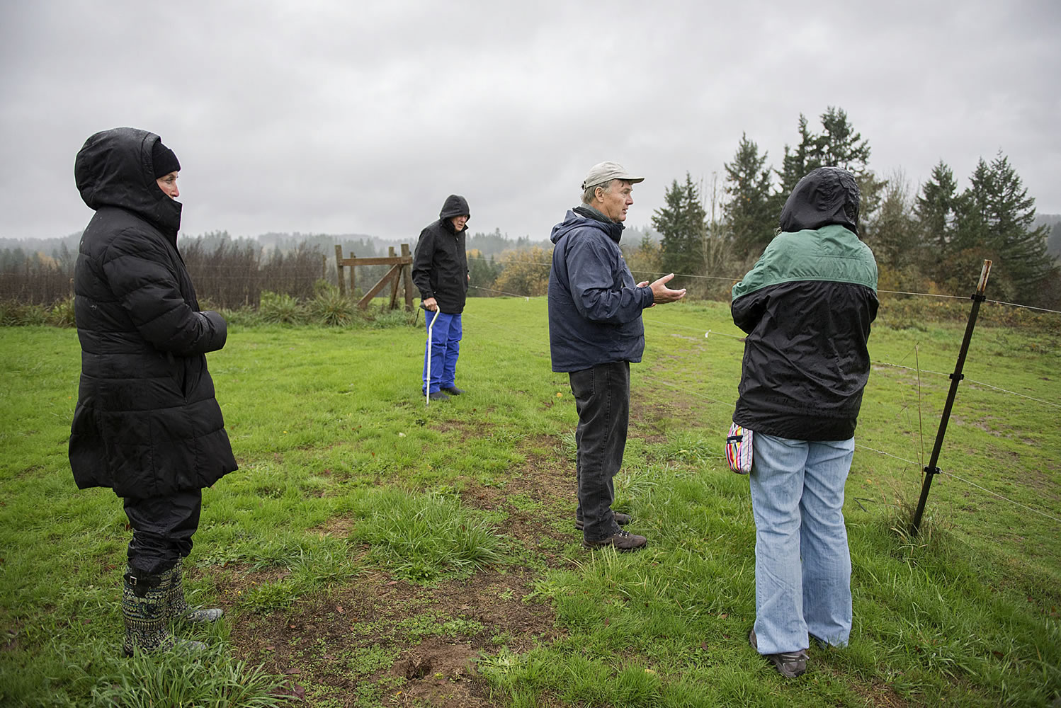 Opponents of a land sale near the East Fork of the Lewis River look over the property recently. The Clark County council voted 2-1 Tuesday to move forward with the sale.