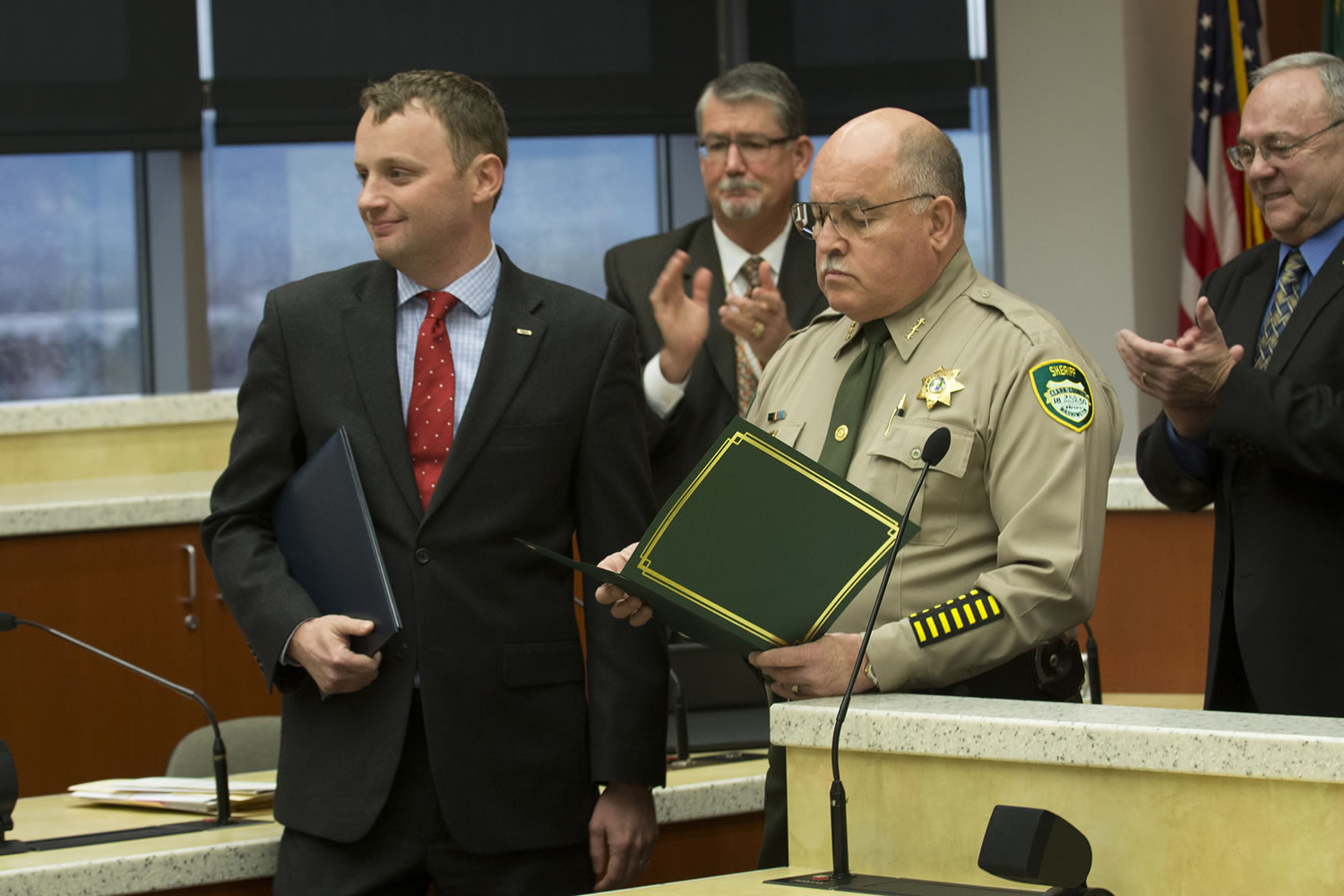Neil Burkhardt, left, who tackled a shooter at the Vancouver Veterans Affairs center on Feb. 4, 2014, receives the county&#039;s Citizen Service medal from then-Sheriff Garry Lucas on Dec. 9, 2014.