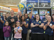 Wal-Mart employees join shoppers and community leaders in celebrating the opening of the Orchards store in September.