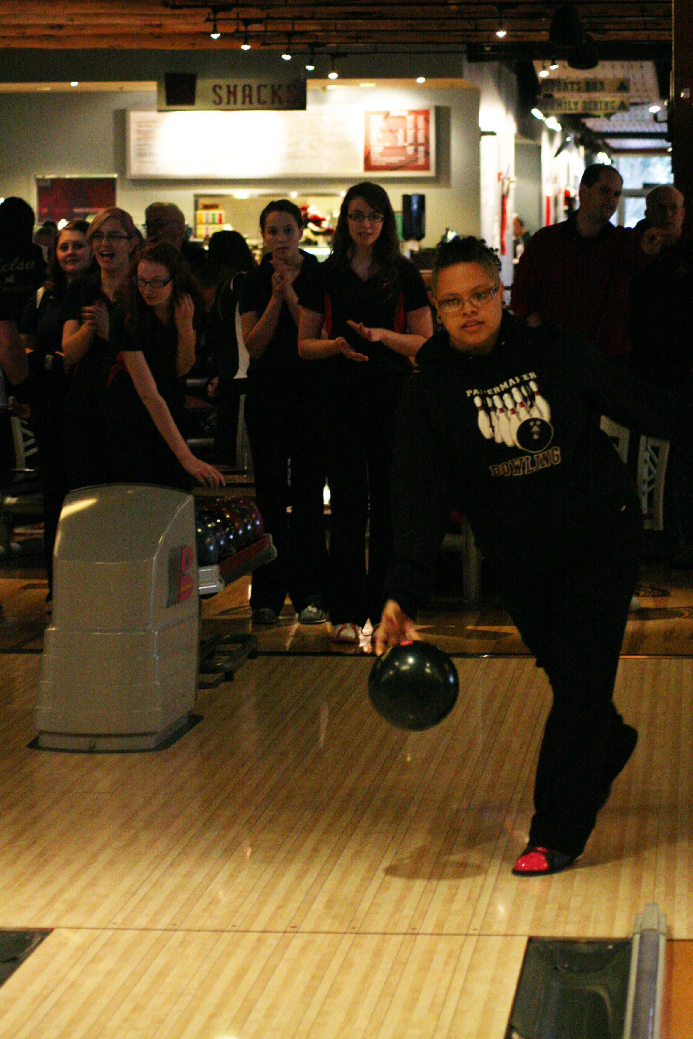Emily McDonald turns the bowling ball loose Wednesday at Big Al's, while Hunter Lytle, Rebekah Curtis, Katie Hull and Porsche Chartrand cheer her on.