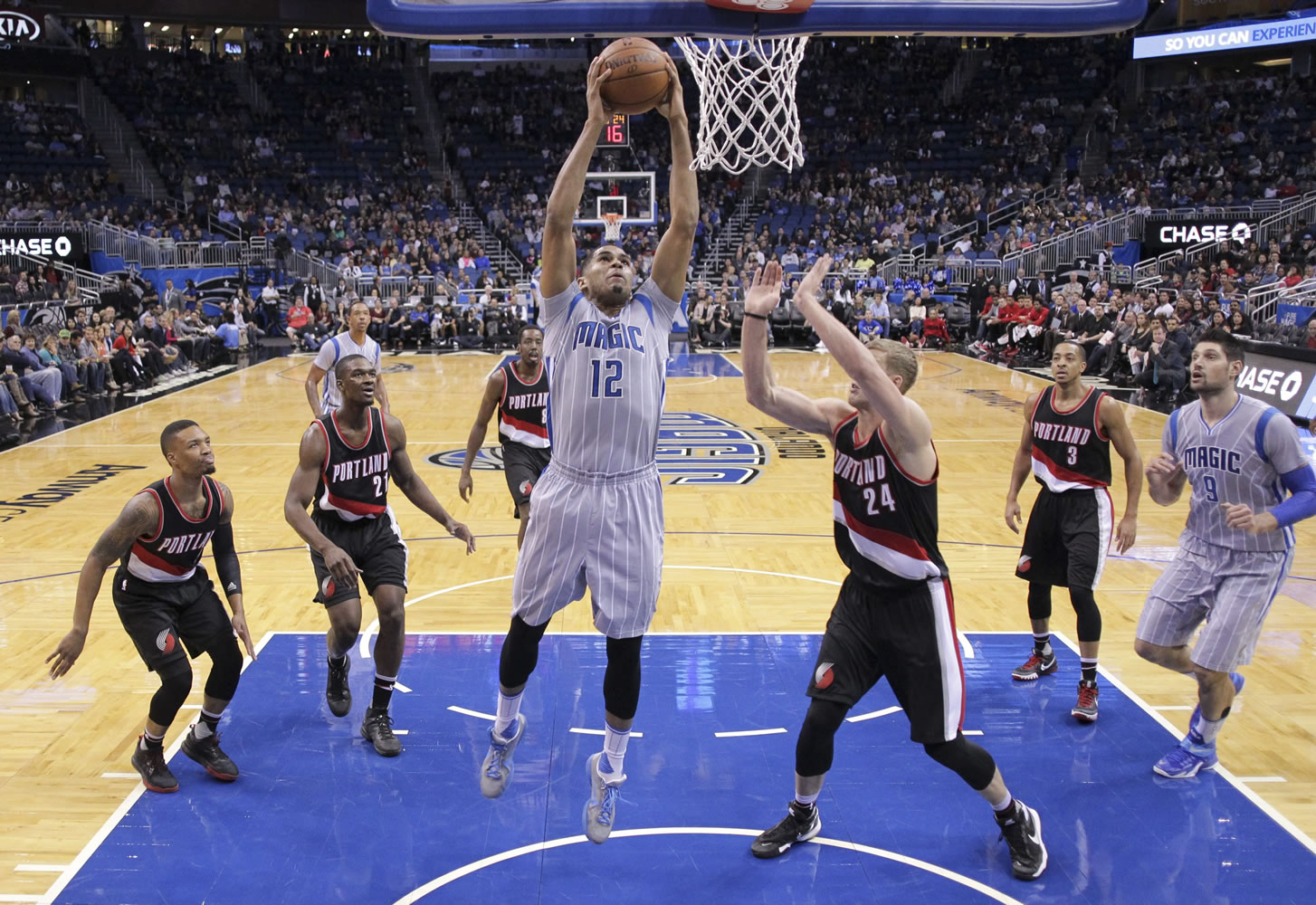 Orlando Magic&#039;s Tobias Harris (12) gets past the Portland Trail Blazers defense for a shot during the first half of an NBA basketball game, Friday, Dec. 18, 2015, in Orlando, Fla.
