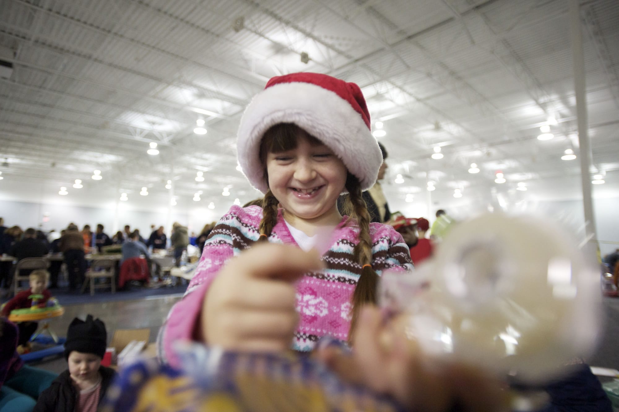 Larissa Crandall, 8, of Vancouver, wraps a donated Christmas gift for a local child.