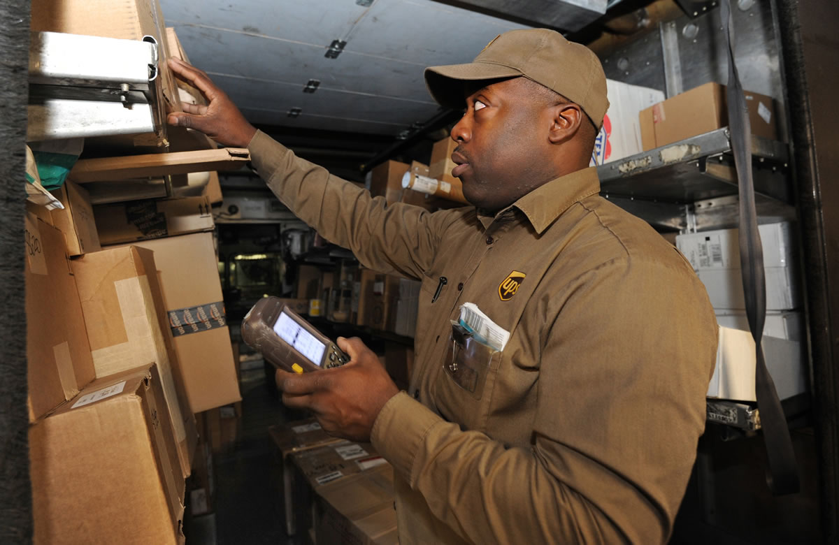 Keith Short, a UPS Service provider and driver, uses a DIAD (Delivery Information Acquisition Device), a hand-held computer, which gives him the delivery information for each package, in Baltimore.