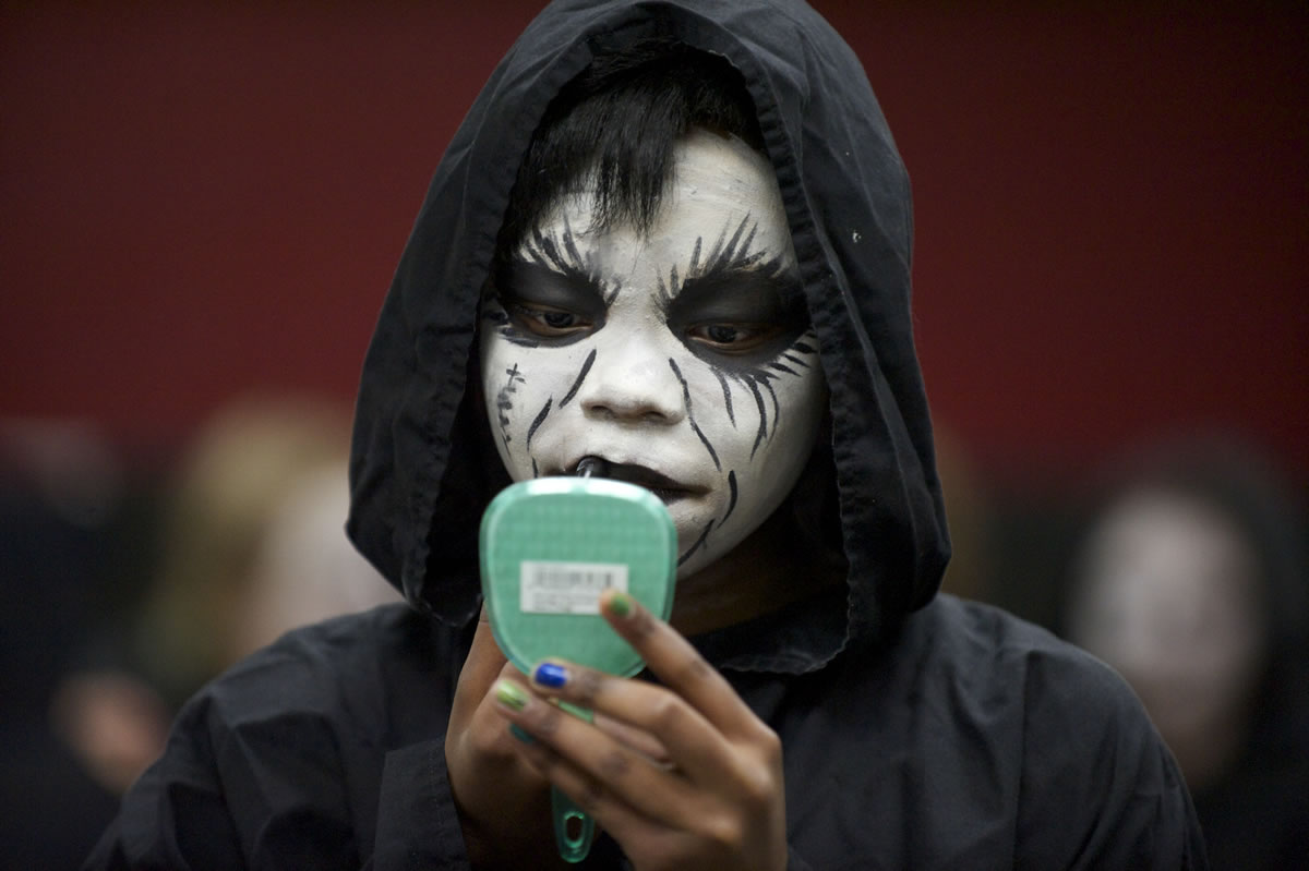 Prairie High School junior Amanda Denson, 16, applies makeup after she &quot;died&quot; in a car crash Tuesday during the Every 15 Minutes program. Students were removed from class by the Grim Reaper and a Sheriff's deputy, made up and returned to class.