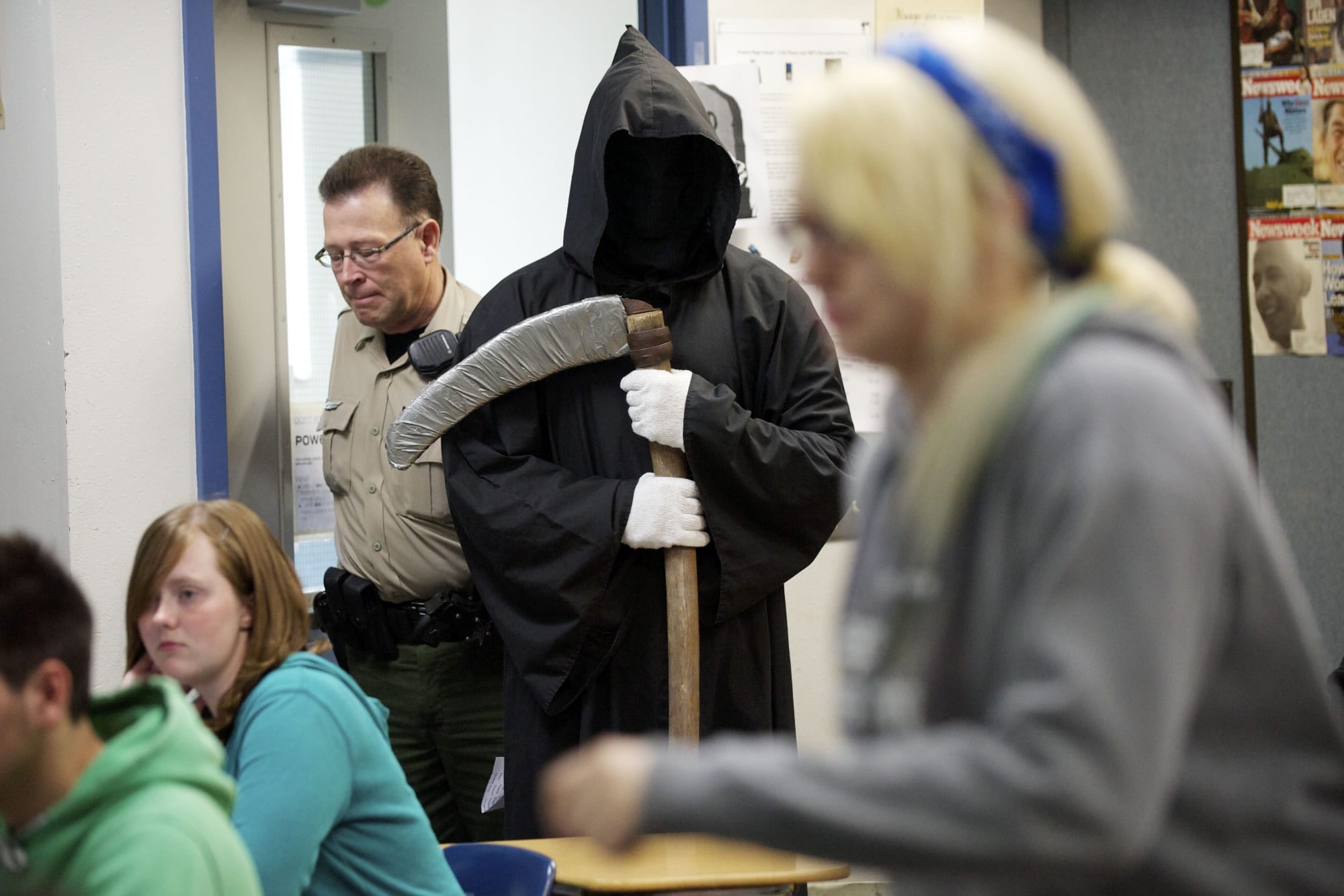 Photos by Steven Lane/The Columbian
The Grim Reaper, played by senior Josh Inman, 18, and Deputy Dwaine Bowden summon Prairie High School junior Justice Wagner, 17, right, from class, as she has just been &quot;killed&quot; in an alcohol-related crash.