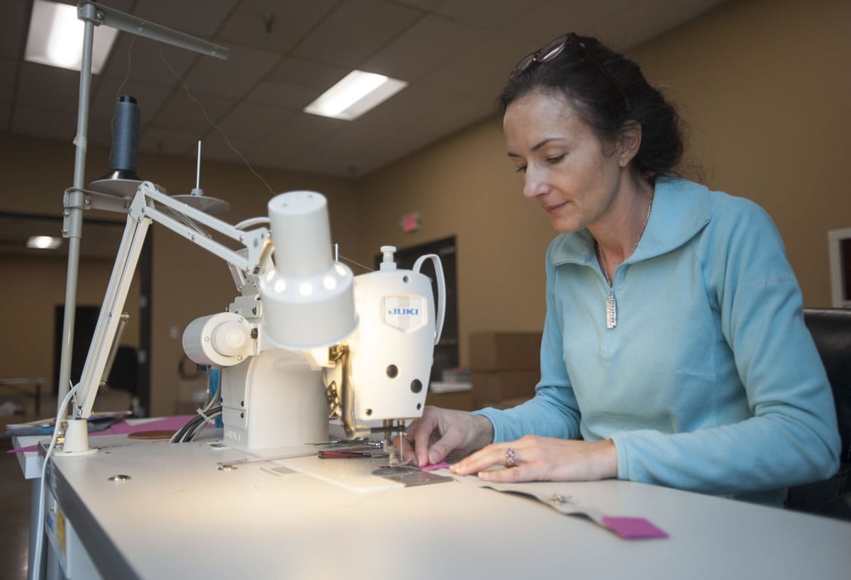 Designer Lisa Tice sews felt pieces onto a bag for an iPad at Last U.S. Bag Company. In addition to its own lines, the Vancouver company provides custom prototyping and manufacturing.
