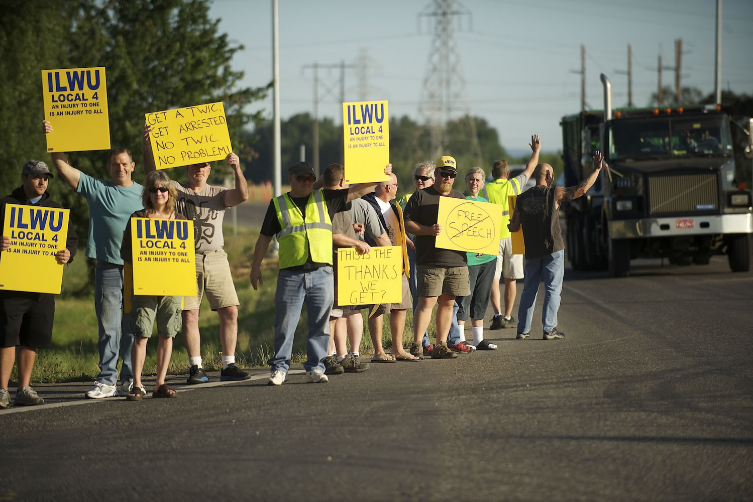 ILWU Local 4 workers and supporters hold signs at the Port of Vancouver during a rally July in Vancouver.