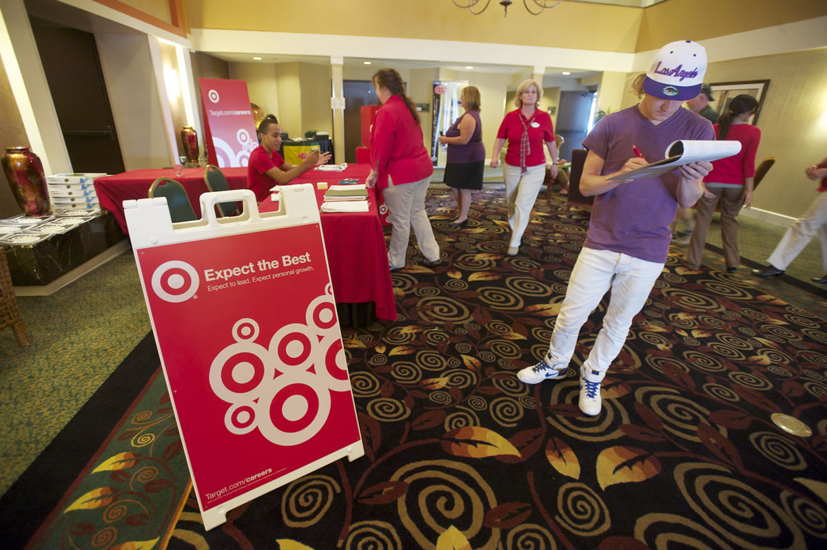 Dean Zack, 22, of Vancouver fills out an application at a Target job fair held at the Red Lion Hotel Vancouver at the Quay on Thursday.
