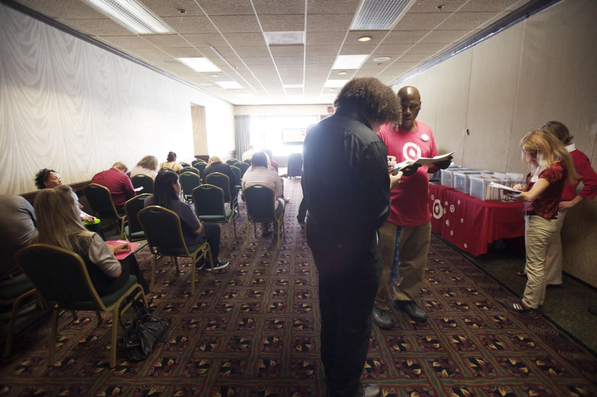 Applicants wait to be interviewed at a Target job fair  at the Red Lion Hotel Vancouver at the Quay on Aug.