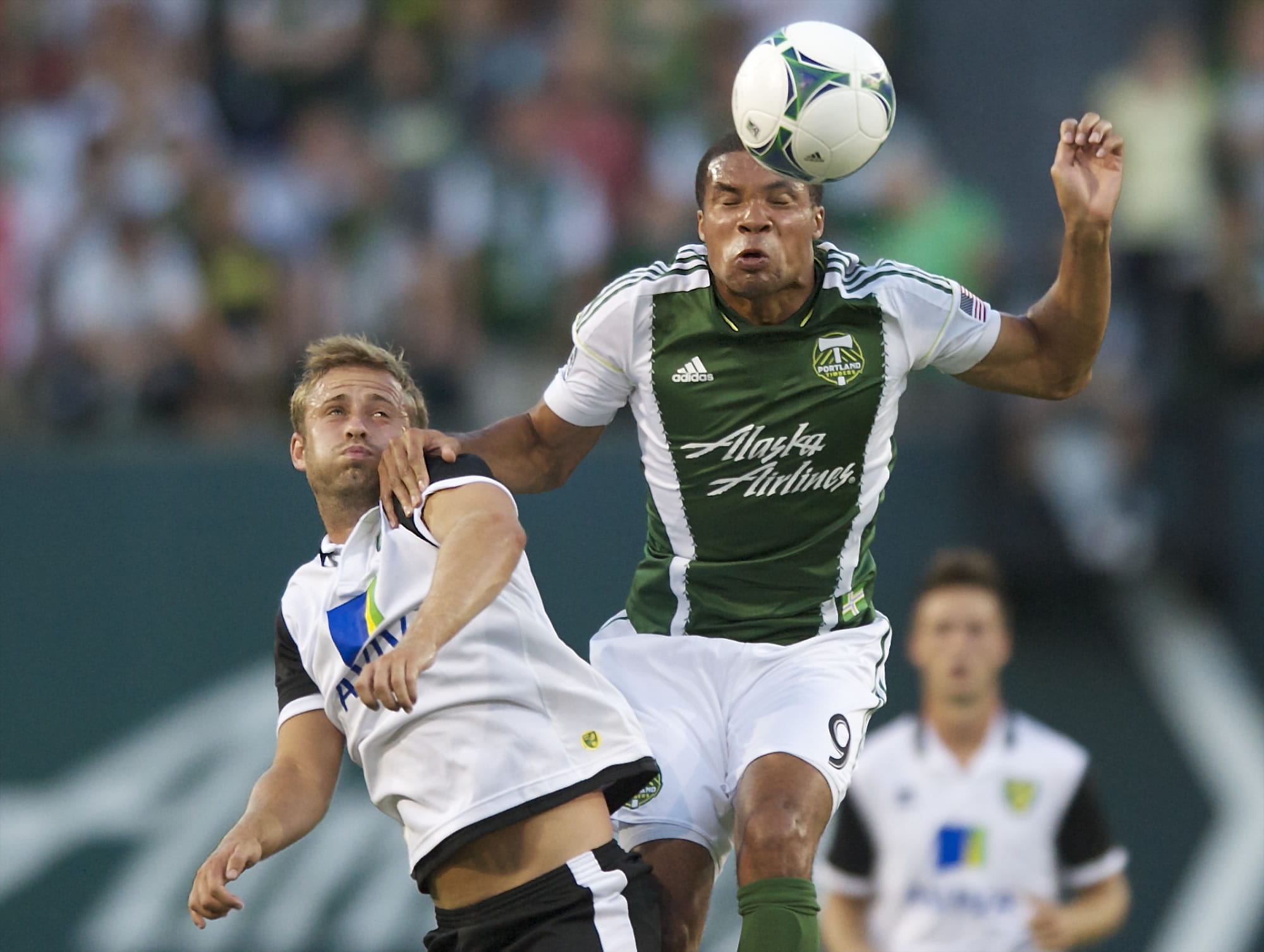 The Portland Timbers' Ryan Johnson gets to the ball before Norwich City midfielder David Fox in the first half at Jeld-Wen Field on Wednesday.