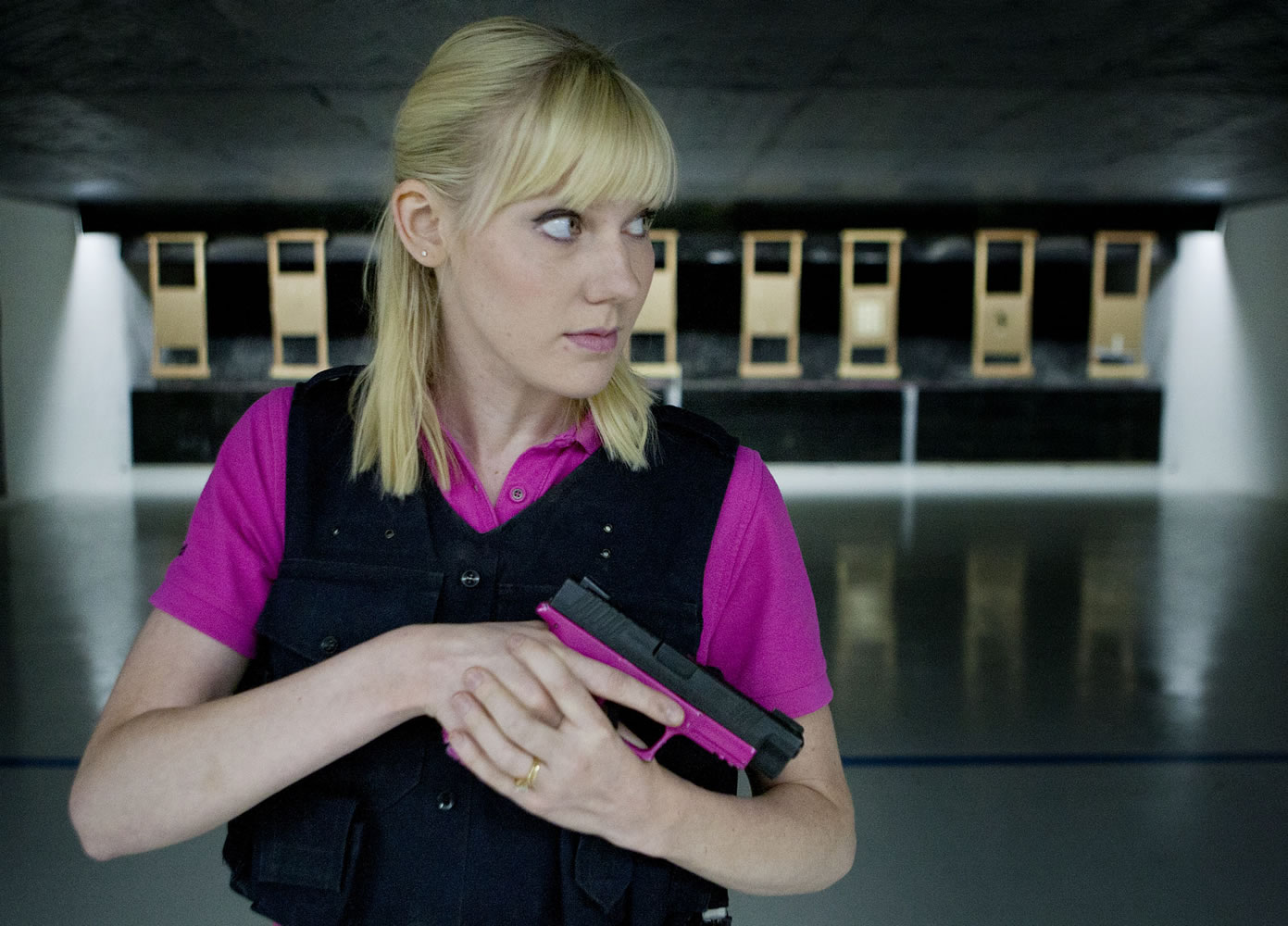 Gracie McKee, here at the indoor range at the Clatskanie Rifle and Pistol Club in Clatskanie, Ore., calls her Springfield XDM 9 mm the &quot;pink gun of shame&quot; because it would be a shame to be shot with it.