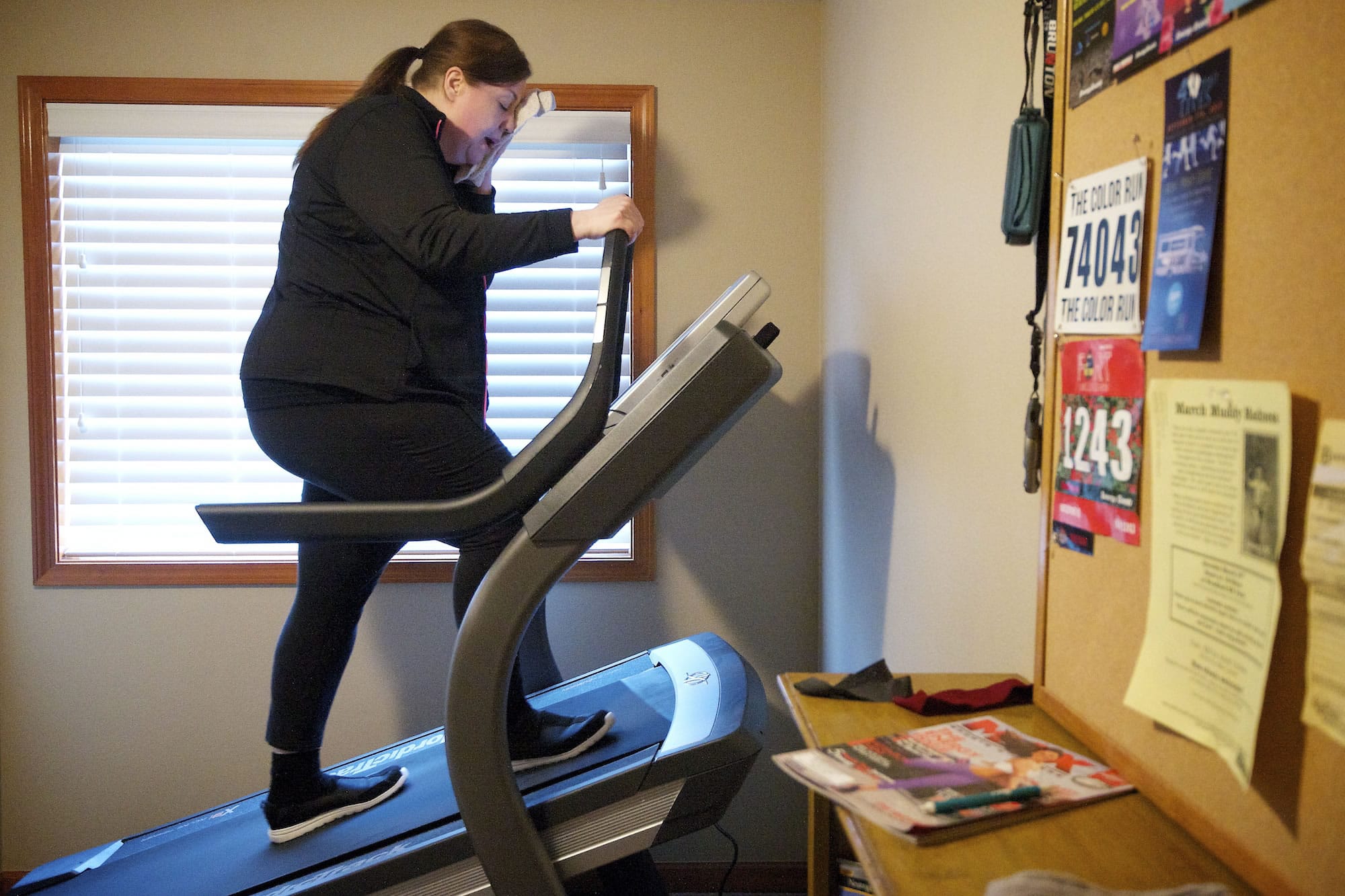 Laina Harris goes through a 20-minute incline workout on her new treadmill in her Camas home Wednesday. Harris uses the steep incline workout and weekend hikes as preparation for an 8-mile hike on Mount St.
