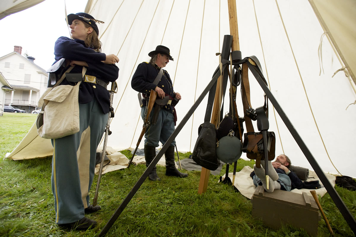 1st Oregon Volunteer Infantry re-enactors make themselves at home in a Sibley tent during a soldiers' bivouac at Vancouver Barracks on Memorial Day.