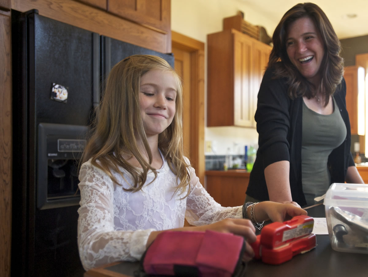 Kari Seekins watches her 8-year-old daughter, Allie, test her blood-sugar level at their Hockinson home Tuesday.