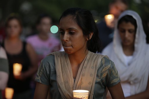 Mourners take part in a candle light vigil for the victims of the Sikh Temple of Wisconsin shooting, in Milwaukee, Sunday, Aug 5, 2012. An unidentified gunman killed six people at a Sikh temple in suburban Milwaukee on Sunday in a rampage that left terrified congregants hiding in closets and others texting friends outside for help.