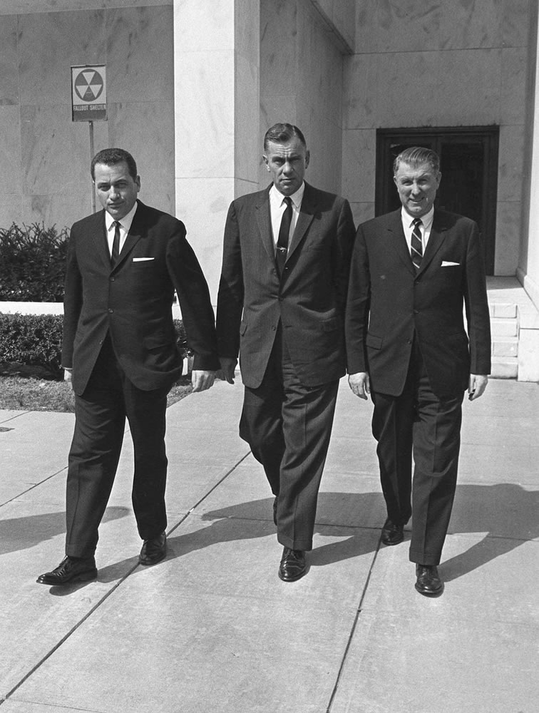 Clint Hill, left, and other Secret Service agents who guarded President Kennedy on the day of his assassination leave during a break in the 1964 presidential commission's investigation.