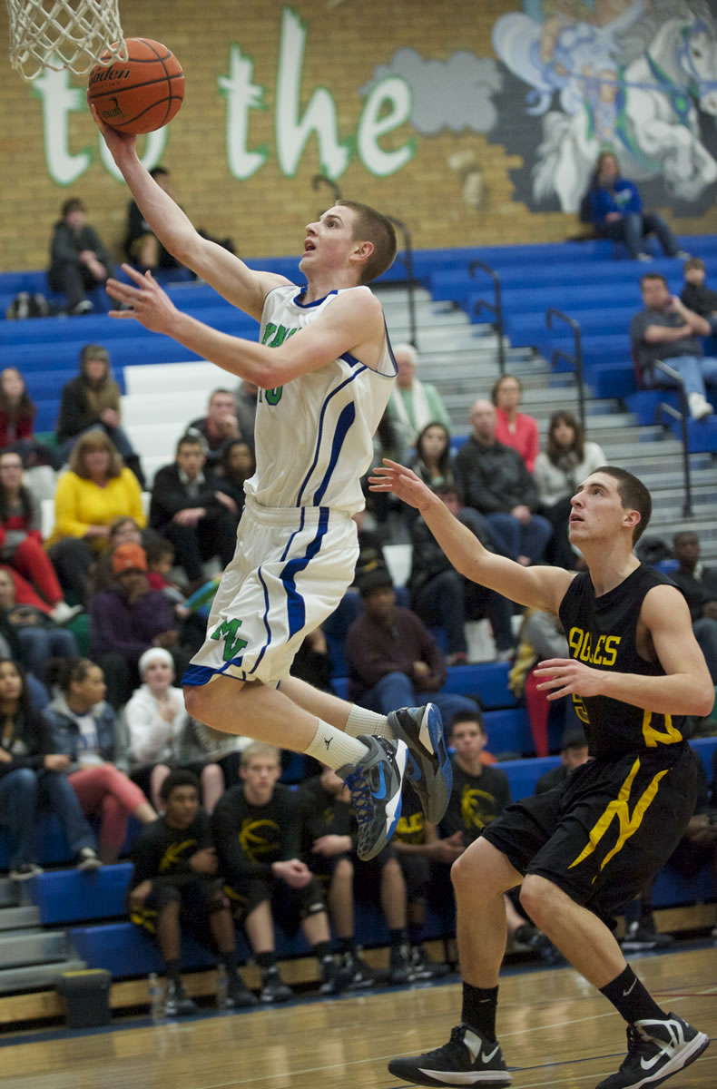 Mountain View's Taylor Drey, left, drives to the basket against Hudson's Bay's Micah Fitzpatrick.