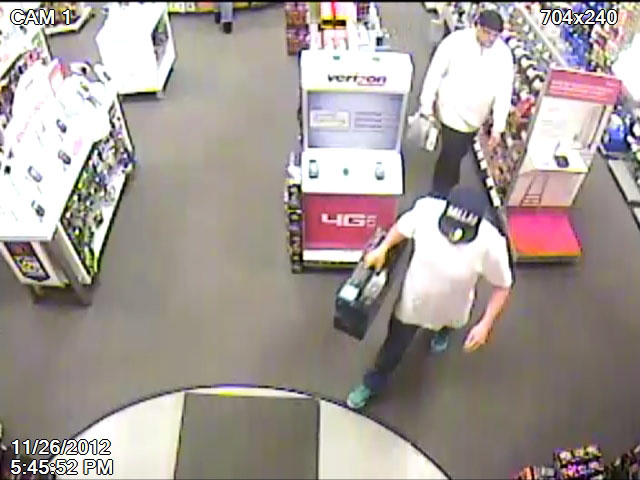 Cowlitz County fraudulent theft suspects appear in a RadioShack surveillance footage.