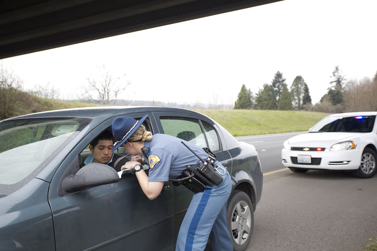 Washington State Patrol Trooper Alexis Tonissen talks to a speeder she pulled over along Interstate 5 in Cowlitz County.