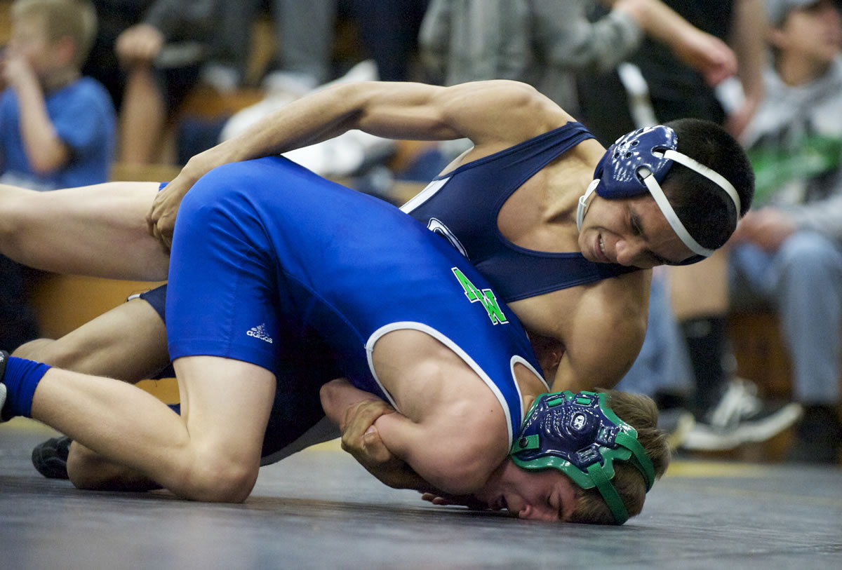 Skyview's Jose Nava-Montez, top, takes down Mountain View's Branden Huft in the 106-pound semifinal at the Pacific Coast Wrestling Championships at Hudson's Bay High School on Saturday.