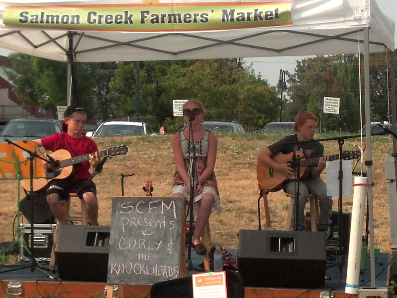 Salmon Creek: Emily Dahlen and guitarists Colton Juenger, left, and Mason Priddy played an acoustic set as &quot;Curly and the Knuckleheads&quot; at the Salmon Creek Farmers Market's Kids Day on Aug.