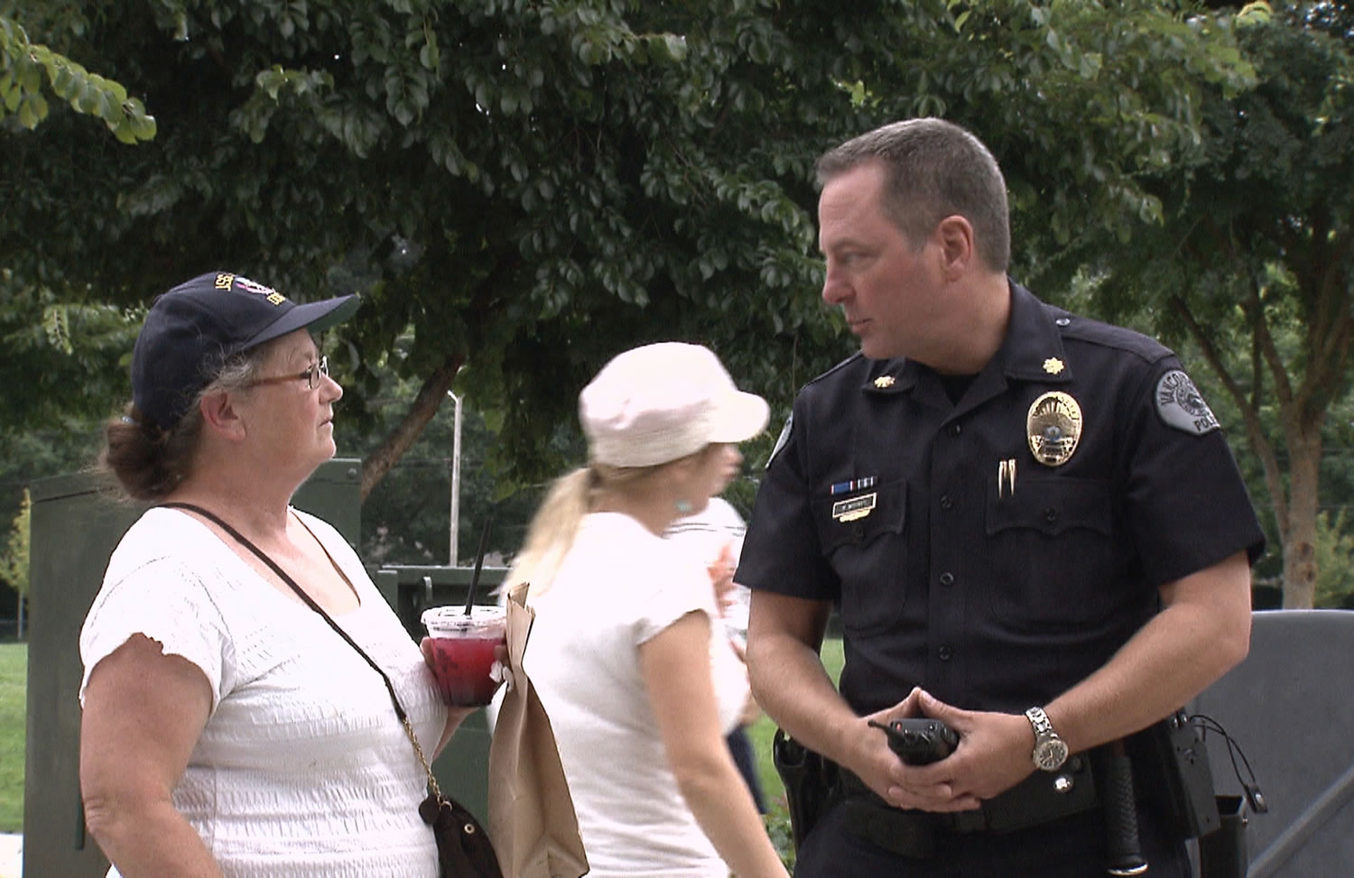 Fircrest: Vancouver Police Department Cmdr. Michael Whitney speaks with Vancouver resident Penny Ross during a Vancouver City Council-hosted community picnic and food drive on Aug.