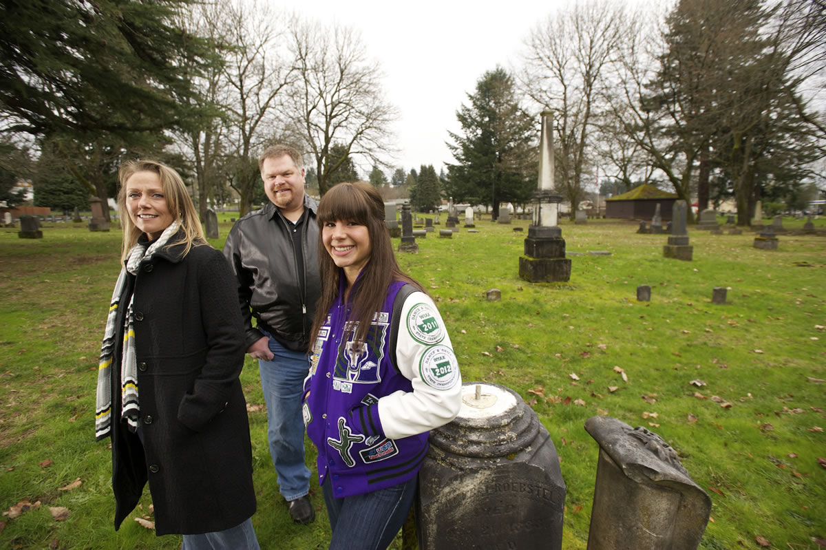 Zoe Hall, 17, a junior at Heritage High School, stands with her parents, John and Dani Hall, in Vancouver's Old City Cemetery in the Central Park Neighborhood.