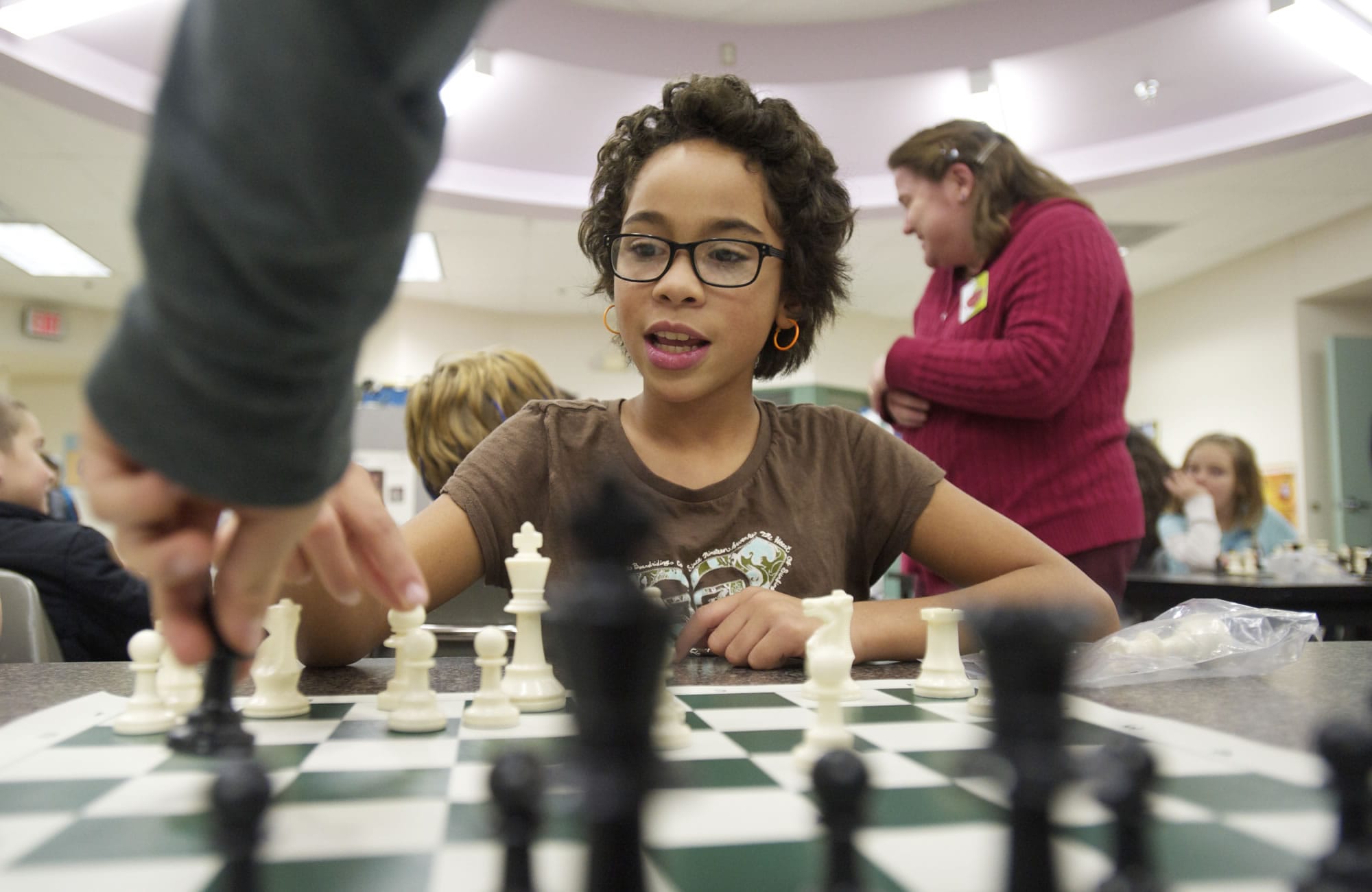 Fourth-grader Brooklyn Munoz, 10, ponders her next move while participating in an after-school chess club, one of many activities offered through Harney Elementary's family and community resource center.