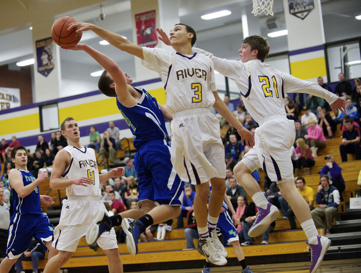 Columbia River's Devin Bolds (3) blocks the shot of Mountain View's Luke DuChesne as River repeated as district champion.
