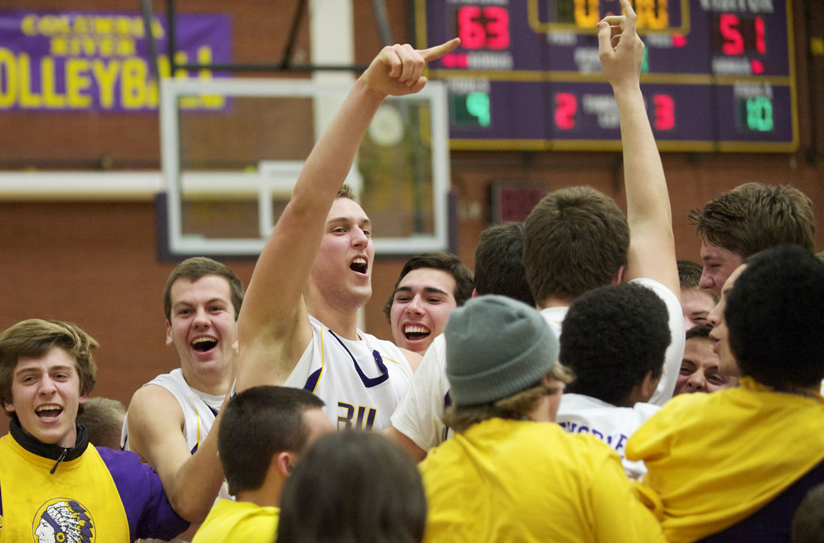 Columbia River celebrates after beating Mountain View at the 3A district basketball finals at Columbia River High School, Friday, February 8, 2013.