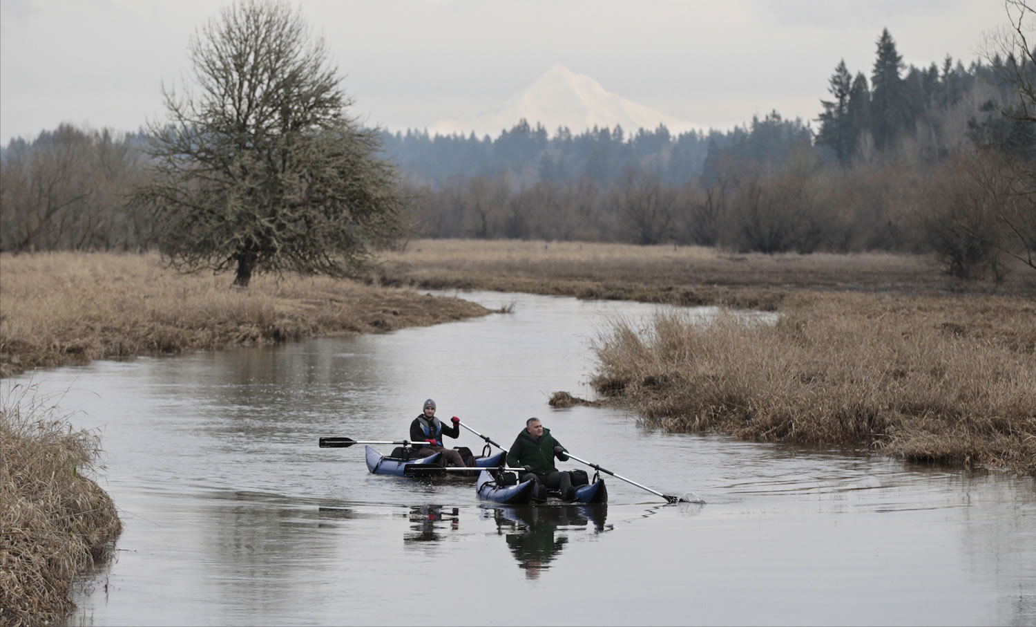 Dennis Pritchard, front, and Sam Pritchard take advantage of plentiful water Saturday to float near the Salmon Creek Greenway Trail.