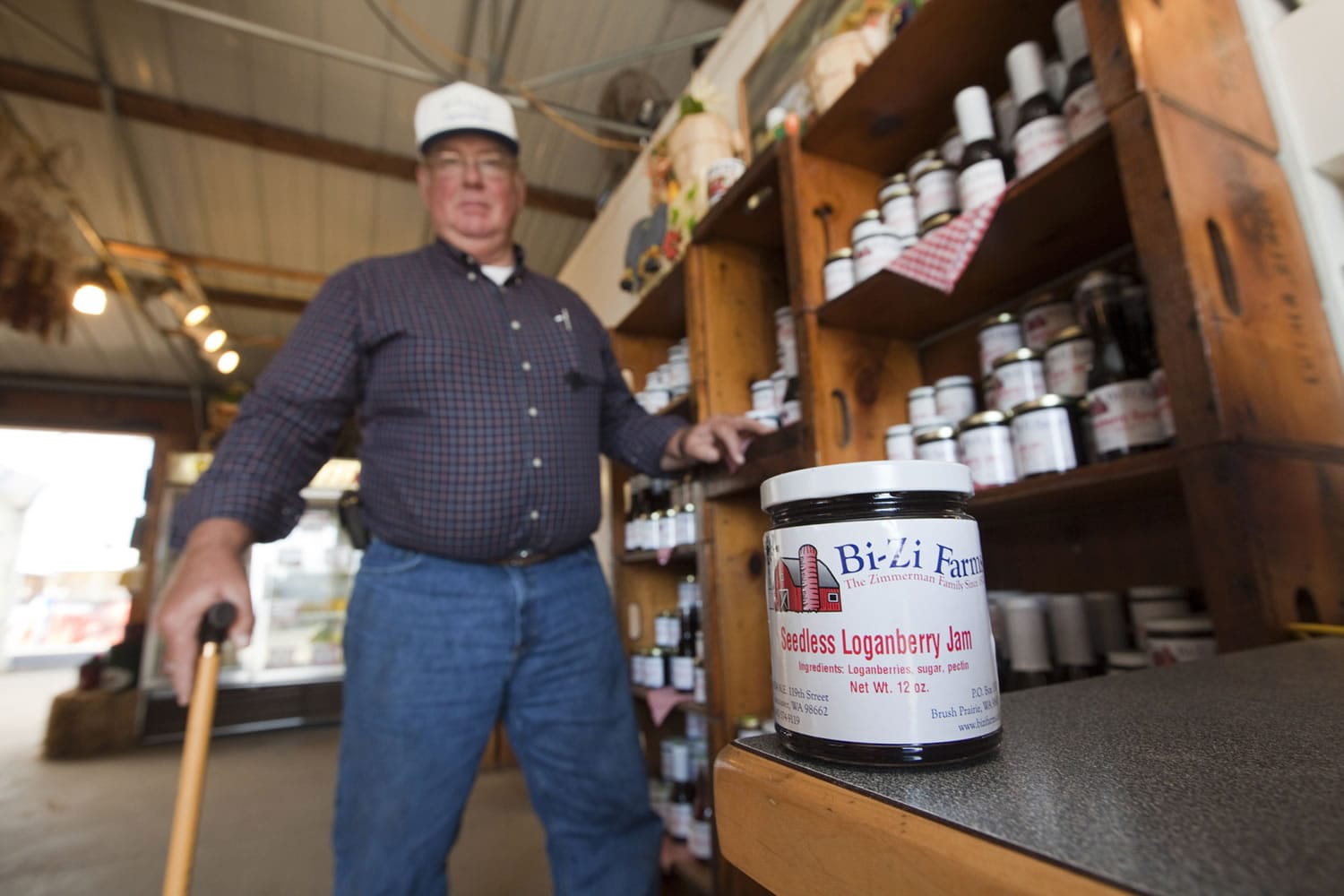 Bill Zimmerman stands next to a display of jams and syrups at Bi-Zi Farms near Vancouver on Monday.