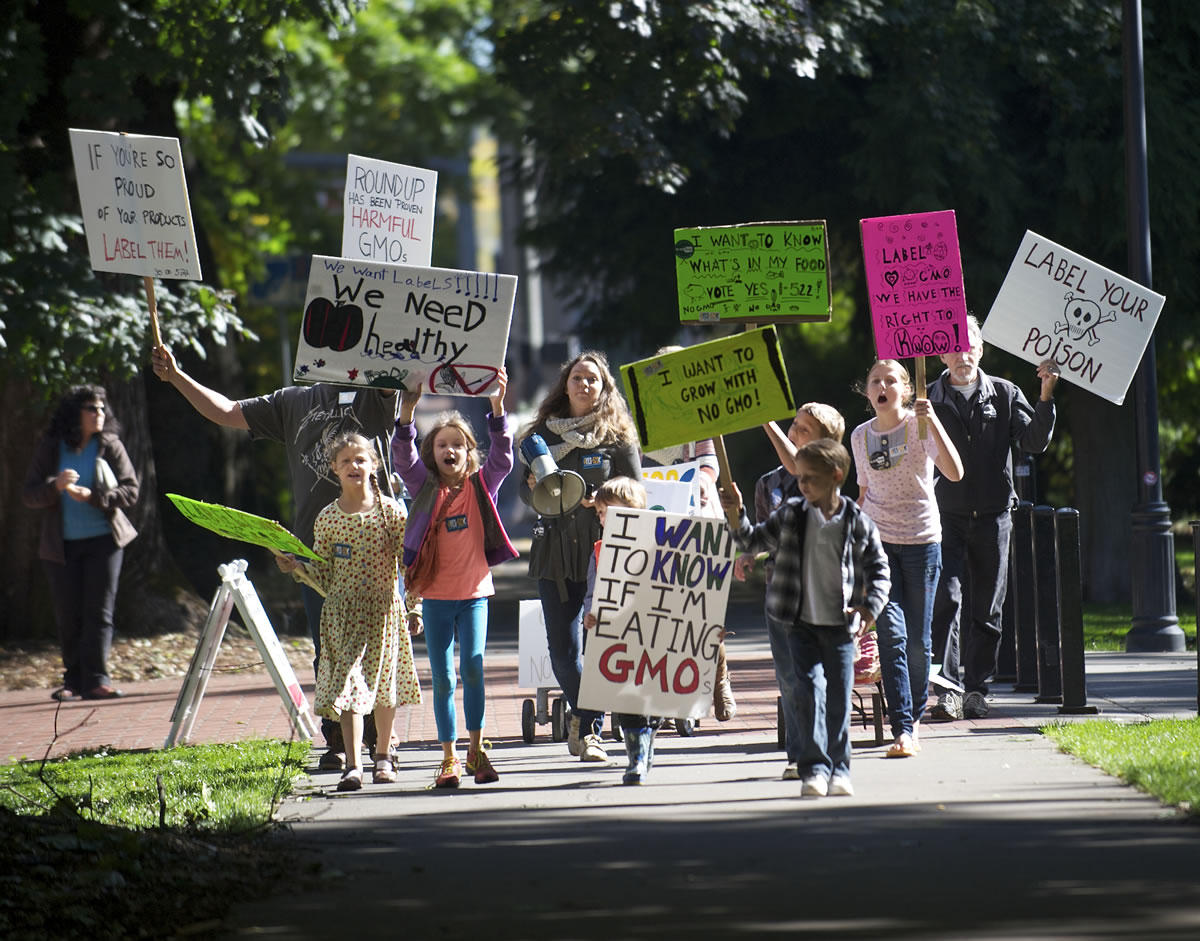 A group marches in Esther Short Park in downtown Vancouver in support of Initiative 522 on Oct.