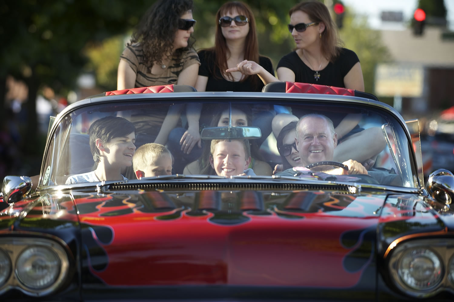 Andrew Scott, 11, from left in the front seat, Andrew Allen, 8, Garret Cochran, 12, and driver Terry Krebser -- plus some passengers Krebser didn't know -- enjoy a ride in his 1958 Chevy Impala on Saturday at the fifth annual Cruisin' the Gut along Main Street in Vancouver.