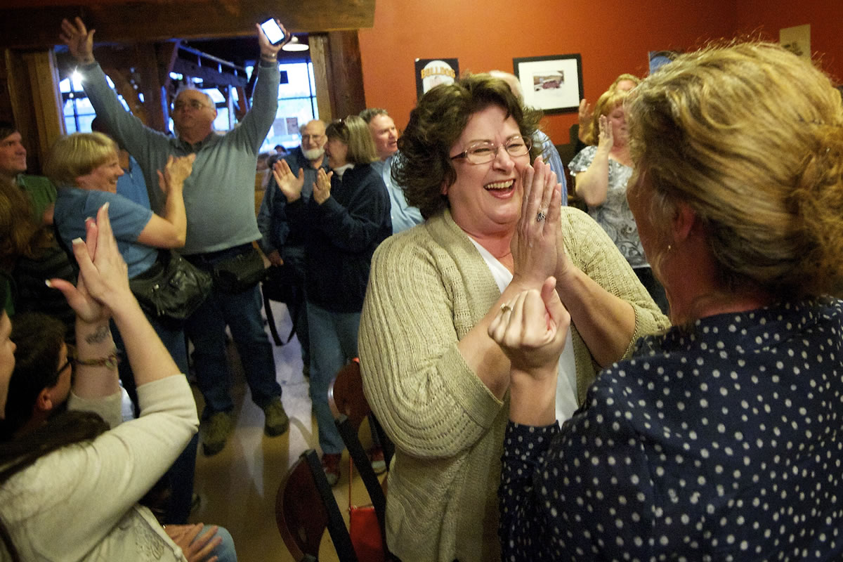 Vicki Sparks, left, with Citizens for Better Schools, celebrates with Cathy Golik, right, as election returns show victory for the Battle Ground school levy Tuesday.