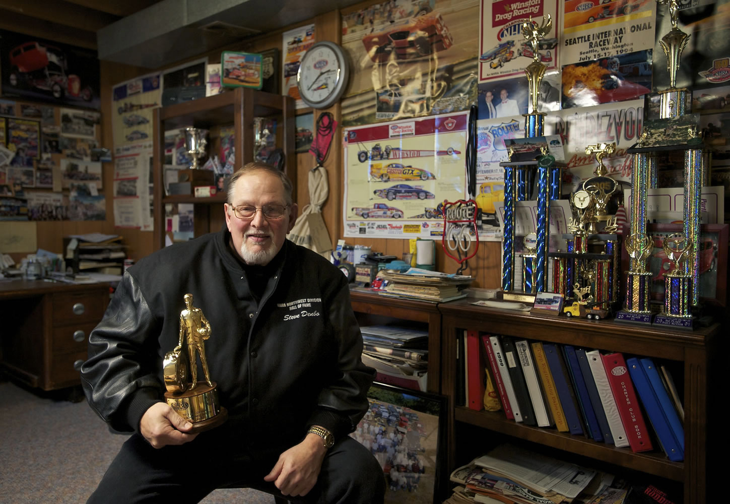Steve Denbo in his Hazel Dell home with the trophy that he received from the NHRA Hall of Fame for the Pacific Northwest in SeaTac.