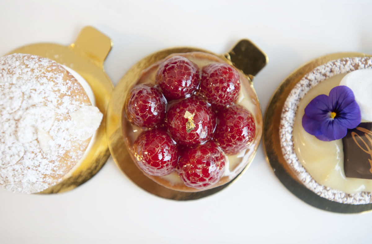 From left, a brioche with custard creme, a raspberry tart and a lemon tart are served Nov. 24 at Baron Patisserie in Vancouver.