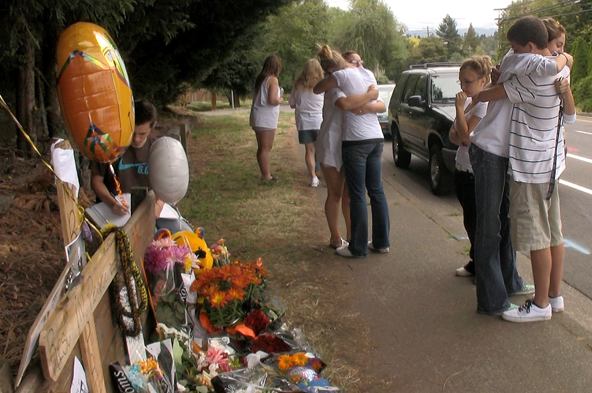 Students from Hudson's Bay High School mourn in September 2009 at a memorial set up on St.