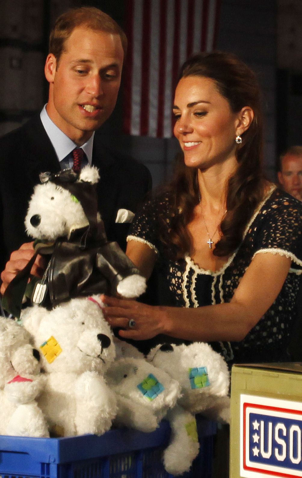 Prince William and his wife, Kate, the Duke and Duchess of Cambridge, look at a stuffed bear destined for children of military families during their July visit to California.