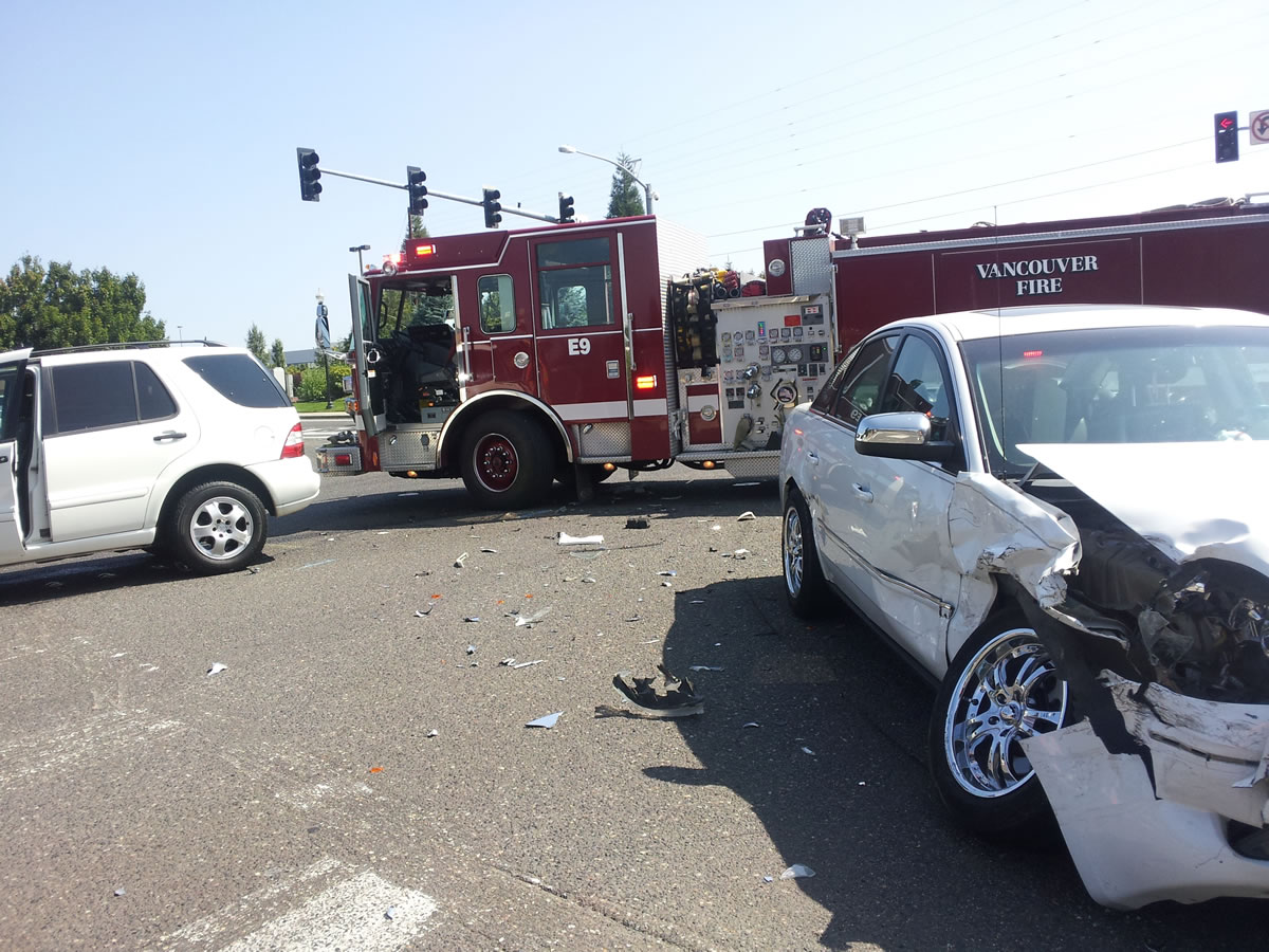 A fire engine shields the scene of a two-car accident Saturday at the intersection of Southeast Mill Plain Boulevard and 164th Avenue in Vancouver.