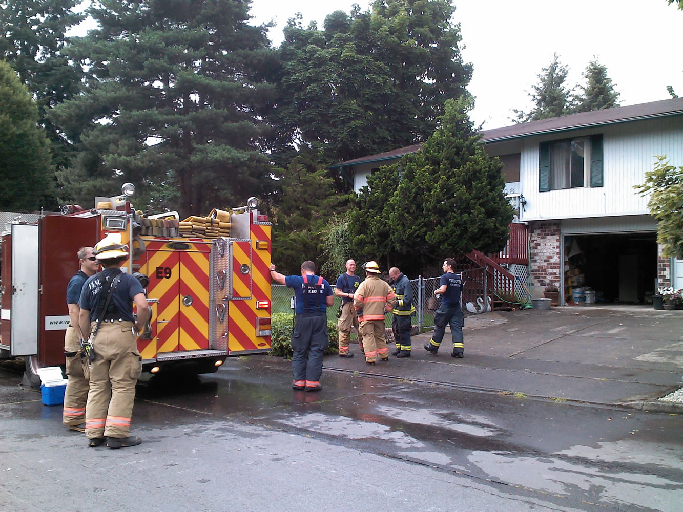Vancouver firefighters take a break after extinguishing a kitchen fire this afternoon.