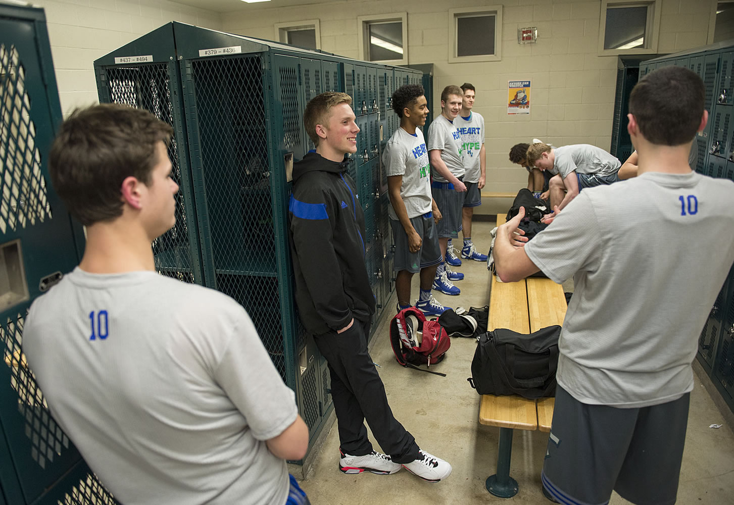 Mountain View senior Jake Ryan, center in black, chats with teammates in the locker room before the game Tuesday night, Dec. 15, 2015 at Heritage High School.