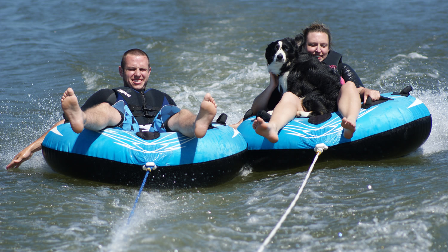 Erin Coburn, right, Stihl, and Coburn's brother, Teddy Coburn, ride on inner tubes towed behind a boat on the Columbia River in July 2011.