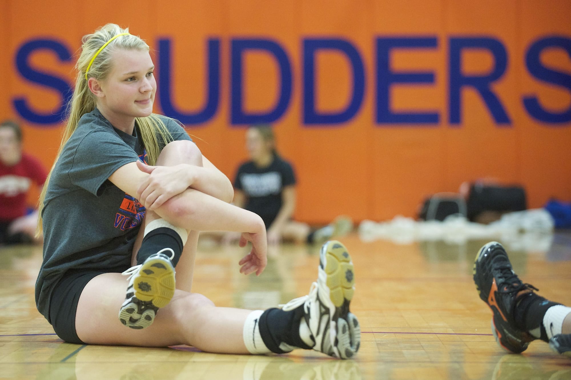 Shannon Boyle of Ridgefield High School stretches before the start of volleyball practice Monday October 14, 2013 in Ridgefield, Washington. Boyle, is a three-sport athlete at Ridgefield.