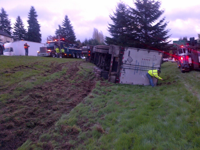 An overturned tractor trailer on Interstate 205 near Northeast Padden Parkway has one southbound lane blocked.