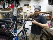 Vancouver Cyclery employee Daniel Muirhead repairs a bicycle.