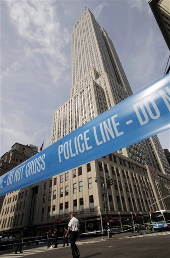 Police crime scene tape blocks 34th Street at Fifth Avenue after a shooting outside the Empire State Building on Friday in New York.
