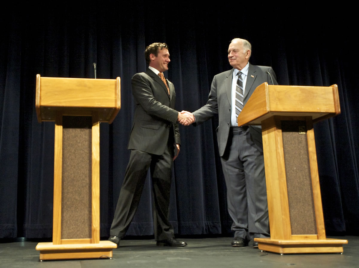 Vancouver Mayor Tim Leavitt and challenger Bill Turlay, a member of the Vancouver City Council, shake hands after a debate in Gaiser Hall at Clark College on Wednesday evening.